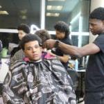 Chief Sealth student barber give another student a haircut.